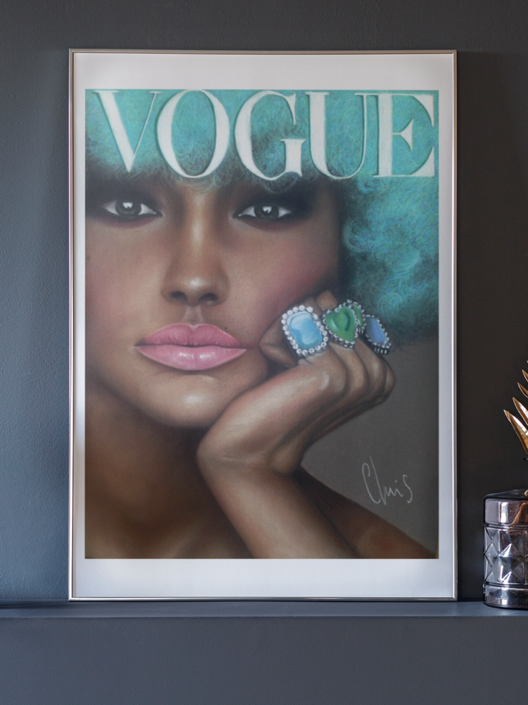 Vogue pastel drawing of a woman with turquise hair, pink lips and blue rings on her fingers in a frame standing on a dark grey shelf next to a gold feather and a pink phone