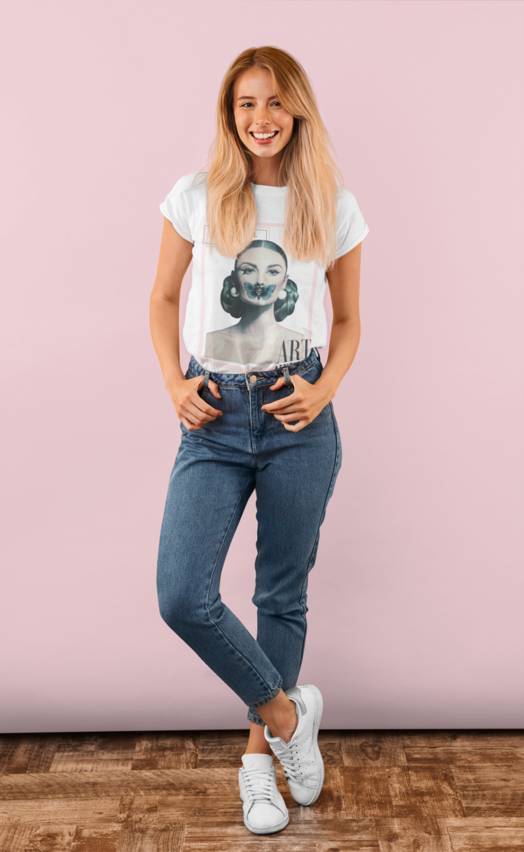 Woman with blond long hair and blue jeans wearing a white t-shit with a motive of a woman with a butterfly over her mouth