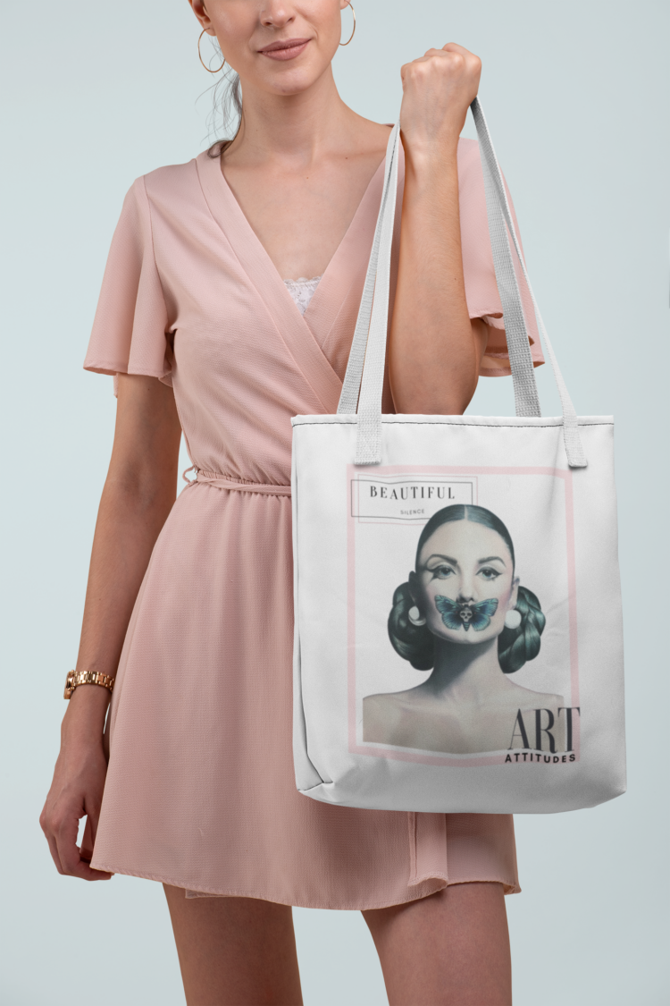 woman in rosa dress holding a white tote bag with a motive of a woman with a butterfly over her mouth
