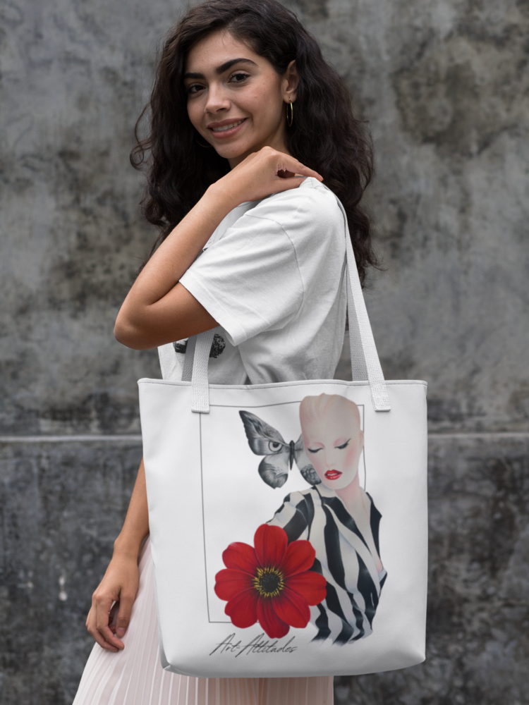 Woman in a skirt carrying a white tote bag with a motive of a woman in a balck and white striped shirt and a big red flower on her right side and a big butterfly next to her head