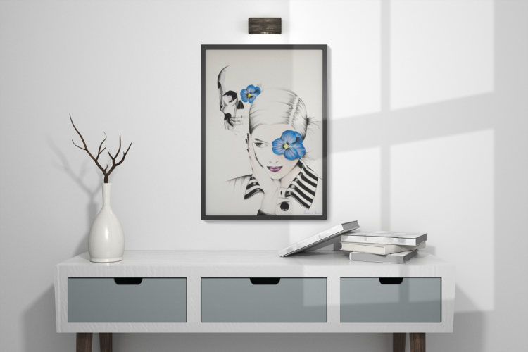 Pastel drawing of woman with blue flower in frent of her left eye in a white shirt with a striped collar and a skull in the bagground with a blue flowe on it's left eye in a black frame hanging on the wall with a white table under it.