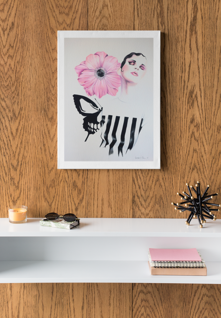 Pastel drawing of a woman in a black and white striped shirt looking up with a pink flower next to her head and a skull butterfly behind her back haning on a wooden wall