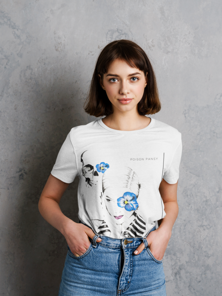 Woman wearing blue jeans and a white t-shirt with an image of woman with blue flower in frent of her left eye in a white shirt with a striped collar and a skull in the bagground with a blue flowe on it's left eye