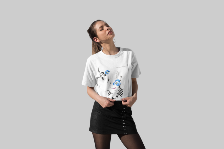 Woman looking up wearing a black skirt and a white t-shirt with an image of woman with blue flower in frent of her left eye in a white shirt with a striped collar and a skull in the bagground with a blue flowe on it's left eye